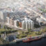 Birds eye artist impression of the charter housing development, showing blocks of apartments adjacent to the riverside green in front of the river ban,