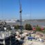Rooftop view of the Charter Development showing a crane and work in progress overlooking the river and blue skies